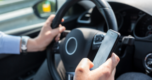 a common cause of auto collisions - a distracted driver on cell phone while behind the wheel 